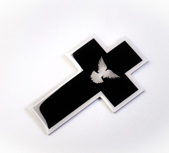 mourning pin in the shape of a cross with a dove